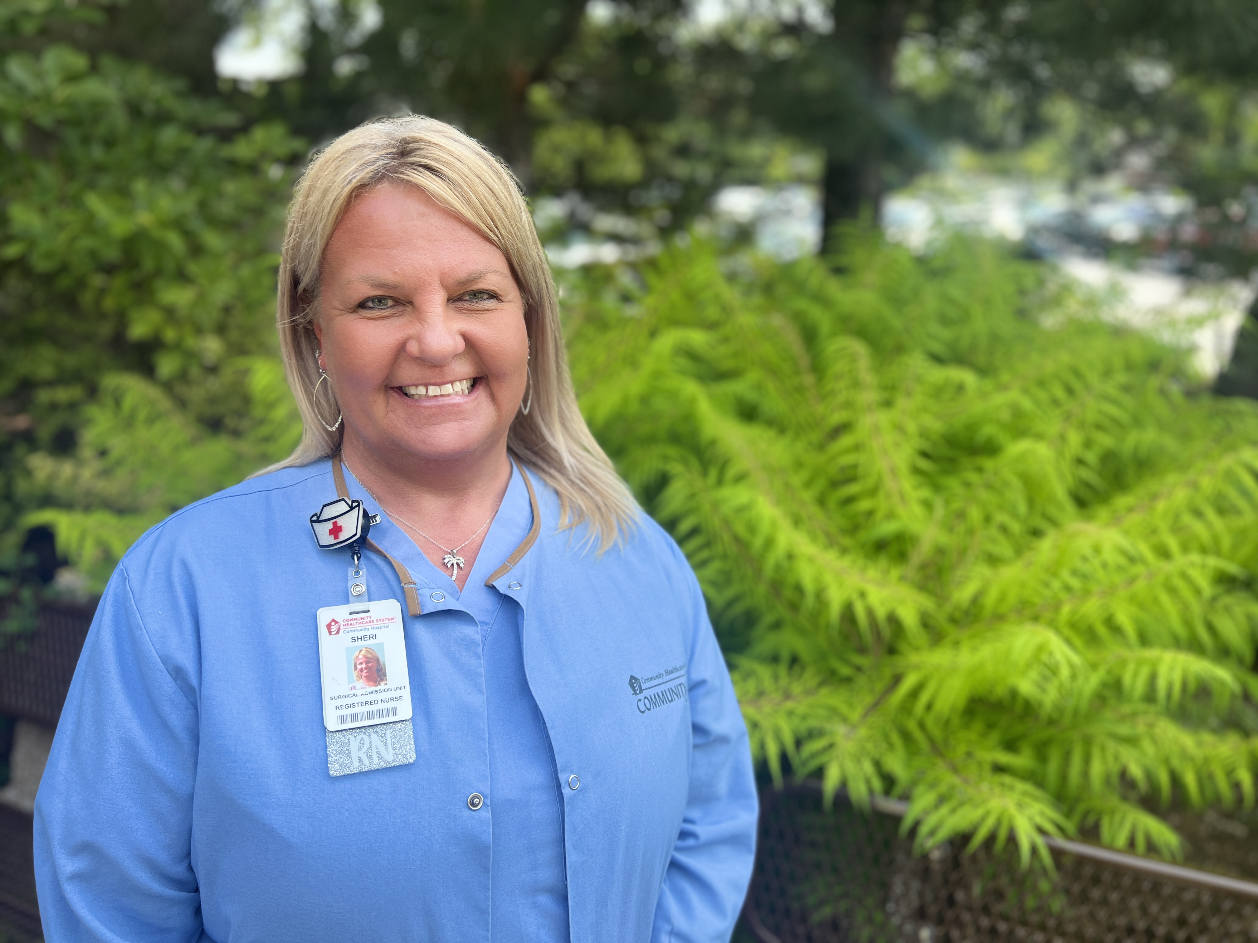 Sheri Rozendal standing in front of a plant